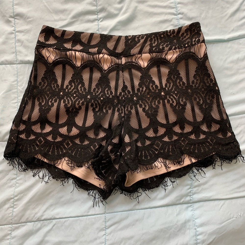 Lace cream and black shorts